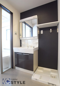 収納たっぷりのシャンプードレッサーにデザインクロスの壁には棚を。