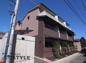 ２色使いの立体的なタイル張りの外観に、共用部のコンクリート打ち放しがオシャレ