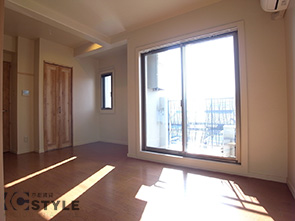 明るく光を取り込むベランダ側の窓。無垢の建具、明るいフローリングのリビング部分（02号室